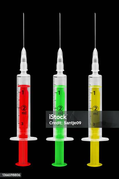 Corona Vaccination And 3 Injections Red Green Yellow On Black Background Stock Photo - Download Image Now