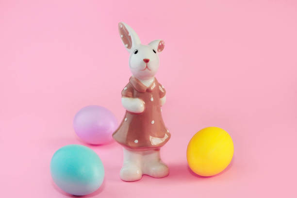 istock bunny in a dress and colorful easter eggs 1366598846