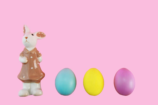 istock bunny in a dress and colorful easter eggs 1366598877