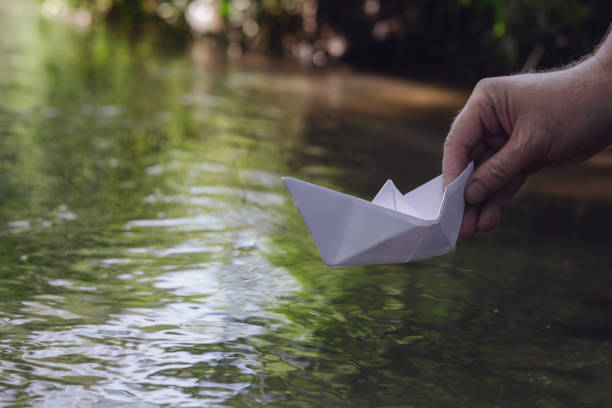 istock Man holds the homemade boat. 1366599822