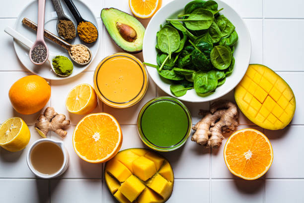 istock Orange ginger smoothie and green spinach smoothie. Detox drinks concept. 1366600199