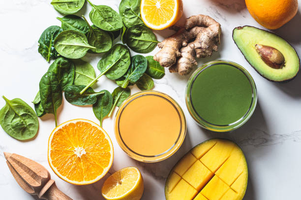 istock Orange ginger smoothie and green spinach smoothie. Detox drinks concept. 1366600215