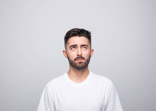 istock Thoughtful young man in white t-shirt 1366600243
