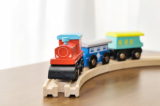 A cute toy locomotive running on the rails