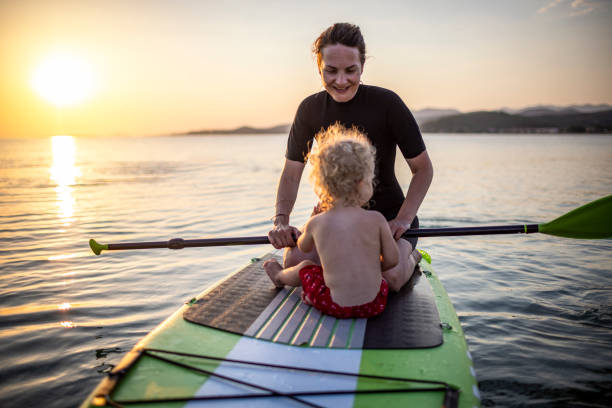istock Mother and son on a paddle board 1366600321