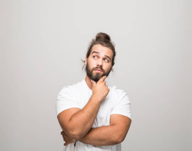 istock Thoughtful young man in white t-shirt 1366600343