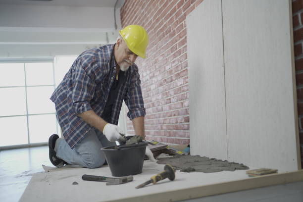 istock Tile mason laying tiles 1366600468