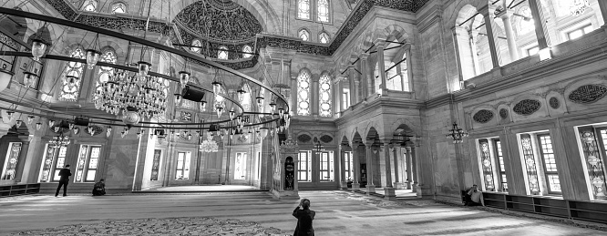 Istanbul, Turkey - October 24, 2014; The interior of Blue Mosque (Sultan Ahmed Mosque) with people praying inside