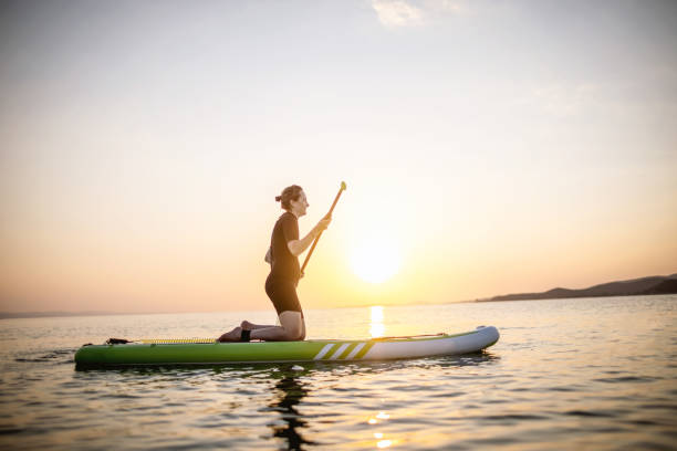 istock Young woman on a paddle board 1366600647