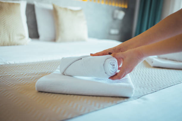 istock Maid with fresh clean towels during housekeeping in a hotel room. 1366600708