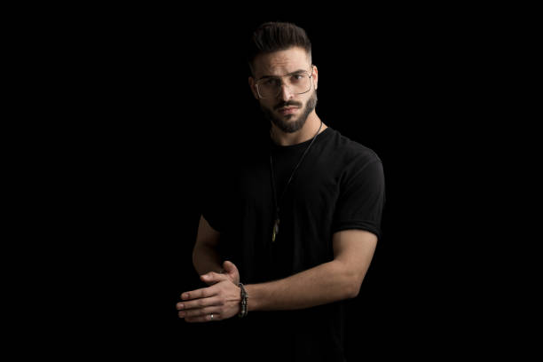 istock bearded young man wearing glasses touching palms 1366601468