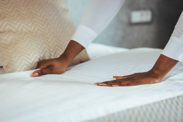 istock Maid working making the bed at a hotel. 1366601584
