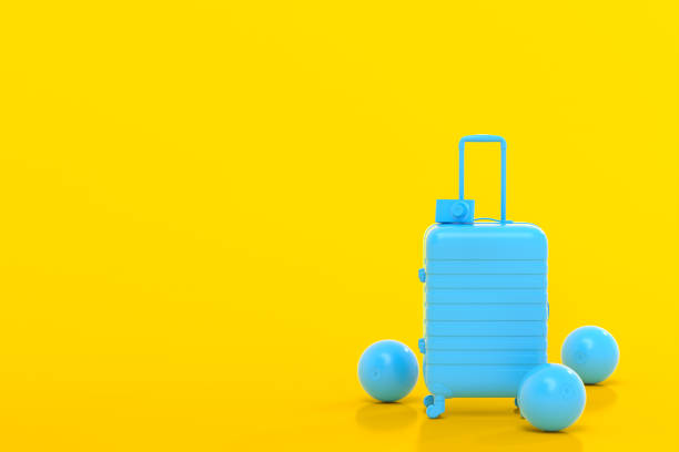 istock Suitcase with beach ball and flip flops on yellow background. 1366601858