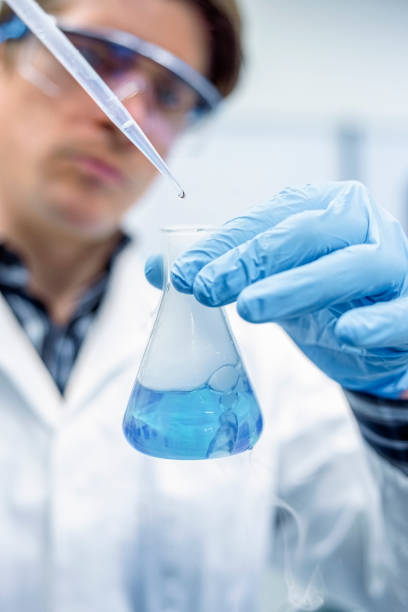 istock Lab technician performing experiments with chemicals in laboratory 1366602041