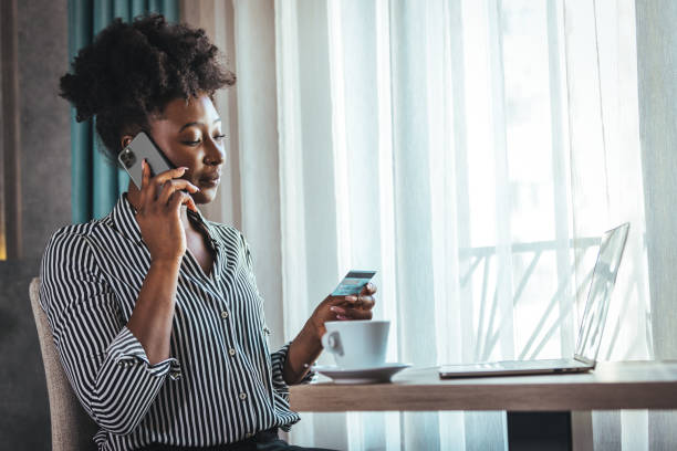 istock Young woman holding credit card and using laptop computer. 1366602204