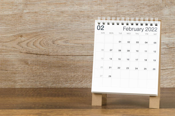 istock February 2022 desk calendar on wooden background. 1366603159