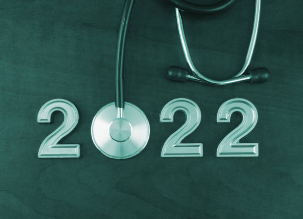 istock Stethoscope and numbers 2022 on wooden table. 1366603832
