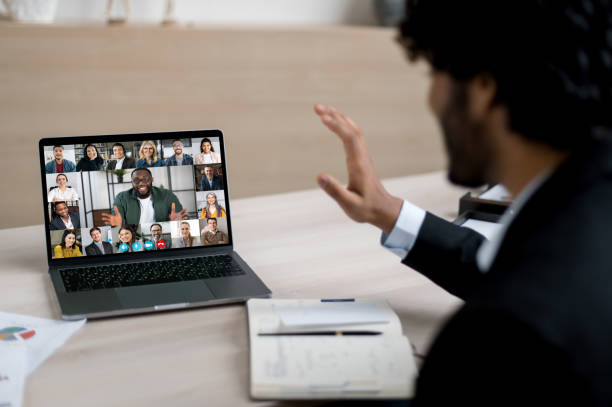 istock Indian successful businessman, ceo or manager communicates via an online conference with colleagues of different nationalities, discusses project, brainstorms employees, waves his hand 1366605414