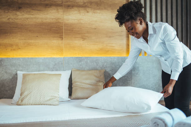 istock Maid making bed in hotel room. 1366606644