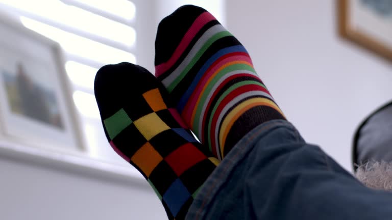 Feet-up relaxing. Multi coloured odd socks.