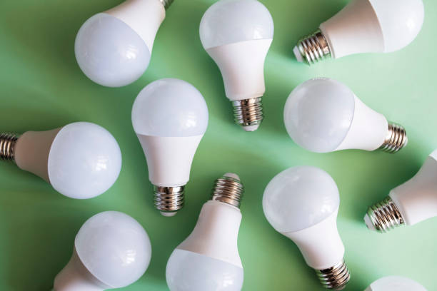 istock Full frame shot of light bulbs against green background. 1366608866