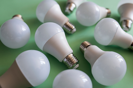Shot of a bunch of lightbulbs on green background.