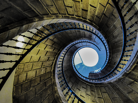 Endless spiral with a balcony heading to the light.