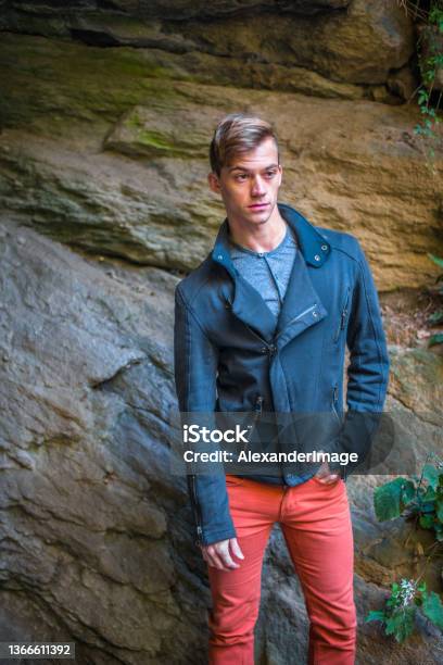 A Young Man Is Standing By Rocks Relaxing Thinkingr Stock Photo - Download Image Now