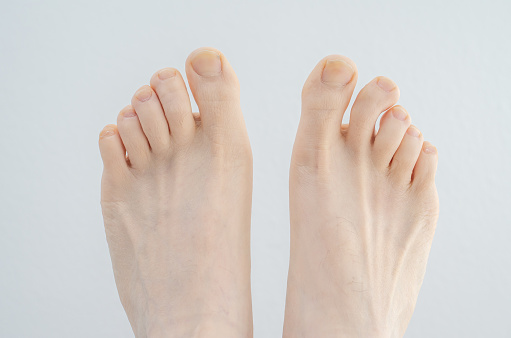 Caucasian male bare feet. Close up shot, isolated on white background, top view.