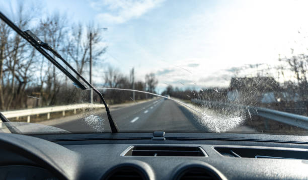 istock Car wipers clean windshields when driving in sunny weather. 1366614850