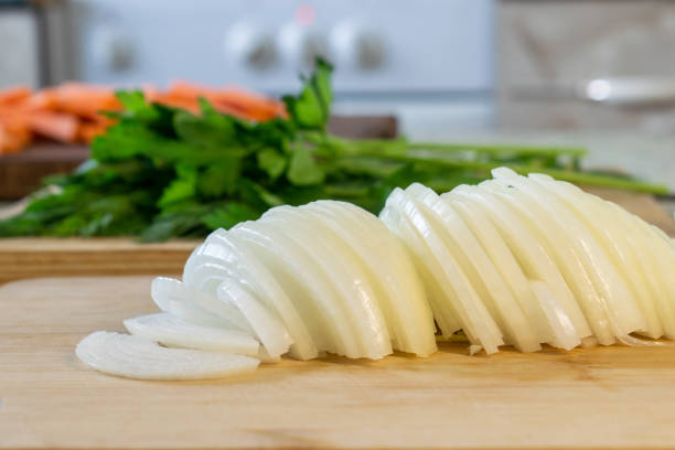 istock Fresh chopped onions on wooden cutting board 1366615073