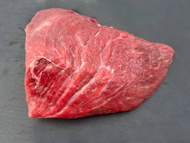 Delicious raw piece of red beef hip part.