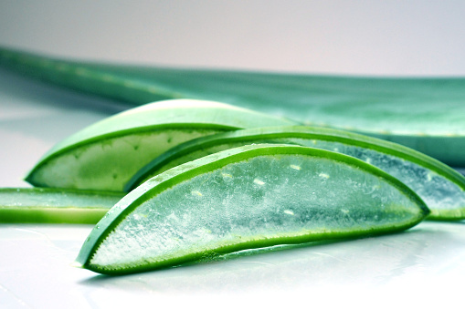 Close-up. Large leaf and thin, transparent slices of Aloe Vera, natural gel.