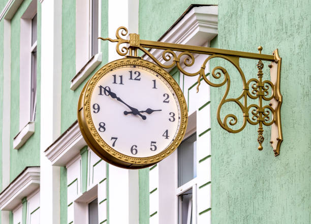 street clock hanging on a wall of brick building - dirty pass imagens e fotografias de stock