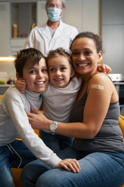 istock Mother with plaster on shoulder with her children 1366618343