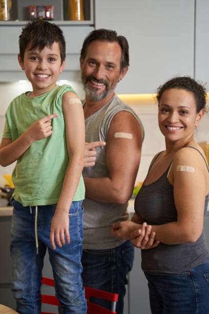 istock Father, mother and son with plasters on shoulders 1366618351