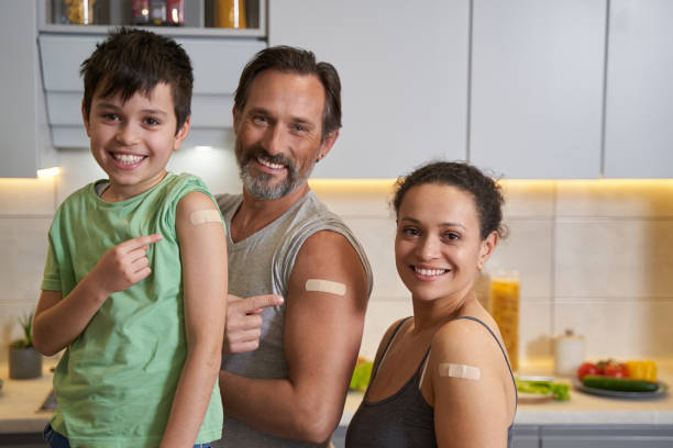 istock Happy parents with child showing their shoulder plasters 1366618355