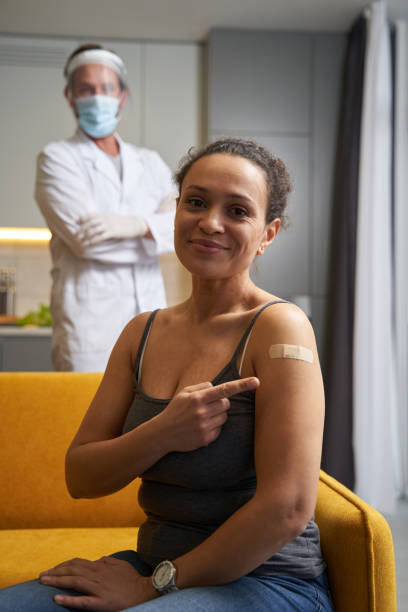istock Pleased lady showing medical plaster on her shoulder 1366618461