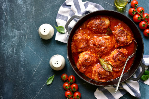 istock Chicken thighs stewed in tomato sauce. Top view with copy space. 1366619412