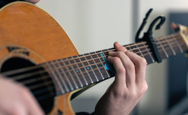 istock Close-up, male hands are playing the guitar. 1366619510