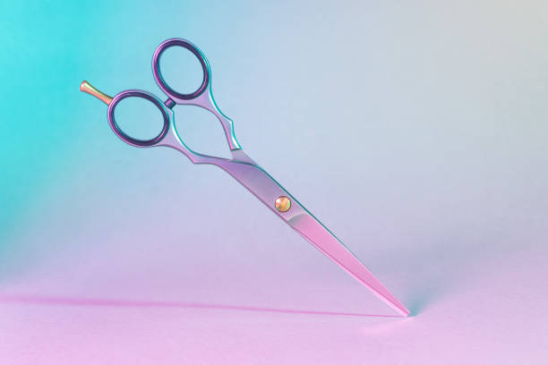 Hair cutting scissors on colorful background. This file is cleaned and retouched.