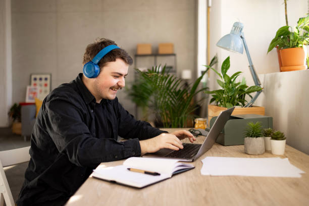 istock Side view of a successful Caucasian man working from home on a laptop 1366621318