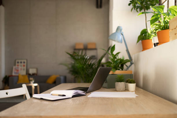 istock Empty home office with no people and a laptop on the table 1366621408