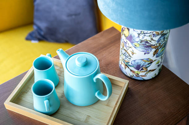 istock Teapot and two blue cups on the table, top view. 1366622379