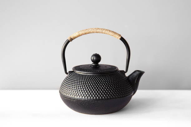 istock Black cast iron teapot on a white background. 1366622380