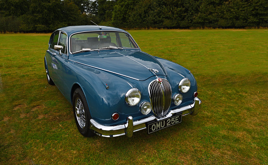 Upper Dean, Bedfordshire, England - September 07, 2019:  Classic Blue 1967 Jaguar Mark 2 3800cc isolated parked on grass.