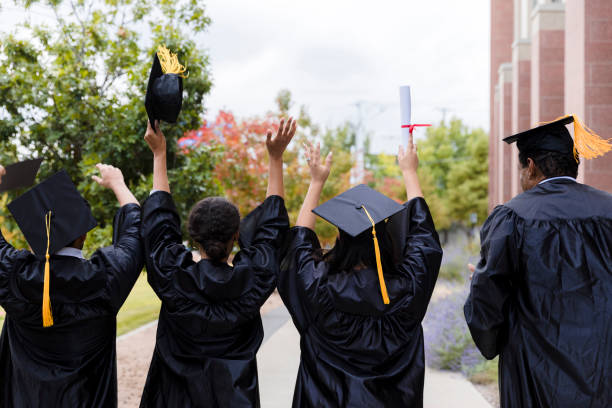 istock Rear view photo cheering graduates 1366623672