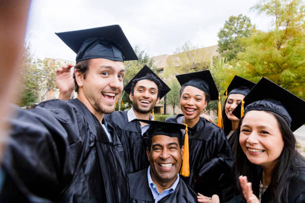 istock Diverse friend group poses for selfie after graduation 1366623688