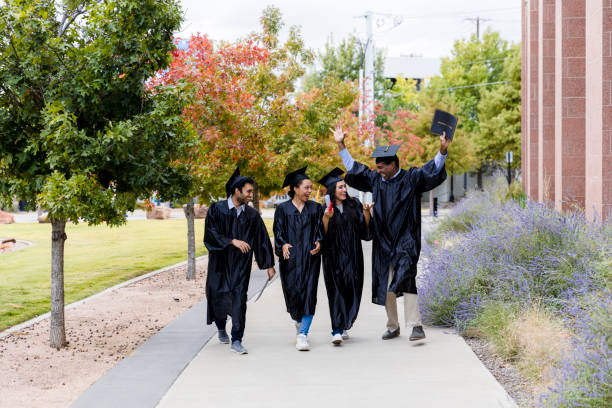 istock College graduates smile and talk after graduation 1366623695