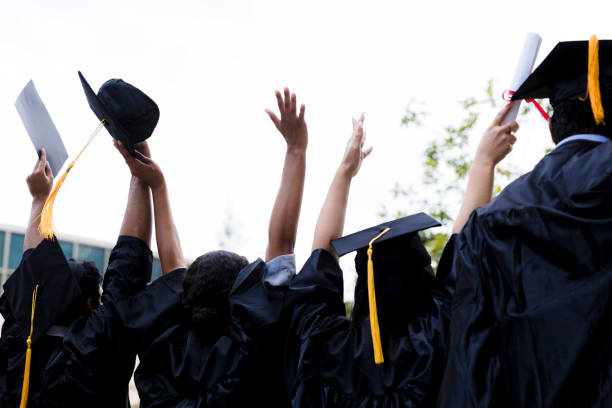 istock Photo unrecognizable graduates cheering with hands raised 1366623765